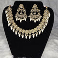 Jewelry set with necklace and earrings on a black stand against a gray background